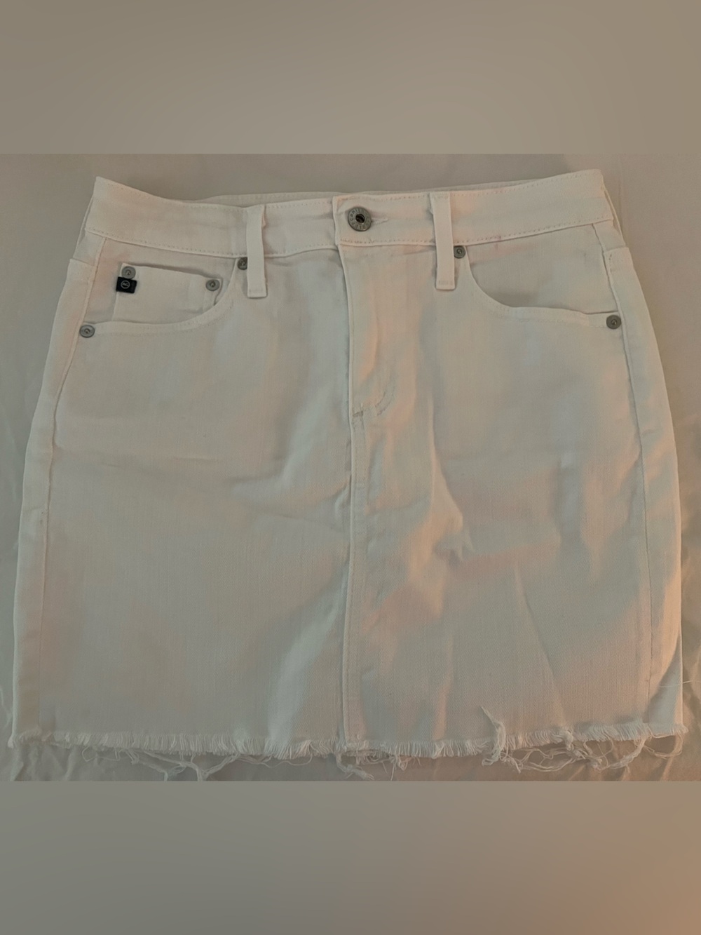 AG Adriano Goldschmied “The Sandy” White Denim Mini Skirt with Raw Hem
